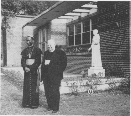 Bishop C. Bowers, Bishop of Ghana, (left) and Archbishop T. J. Toolen, Bishop of
Mobile-Birmingham, standing before the statue of St. Martin de Poores